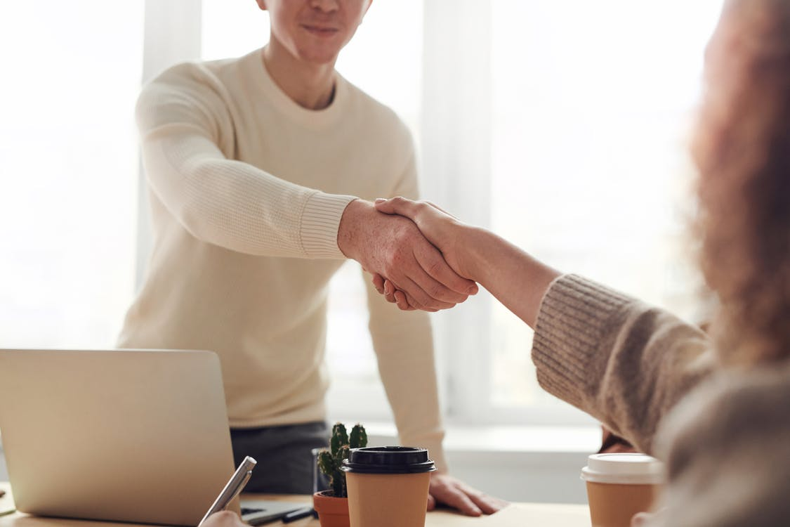 Homeowner shaking hands with an insurance agency professional
